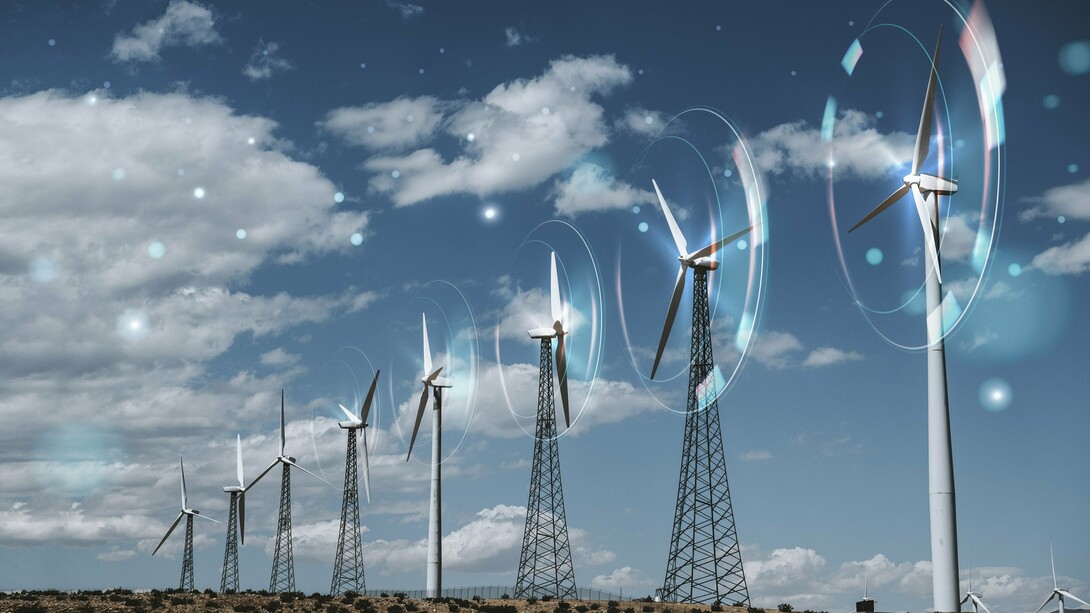 A row of sleek, modern wind turbines stands tall against a vibrant sky, visually representing the significant advancements and growing importance of wind energy in the renewable sector