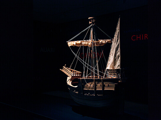 Lothar Baumgarten, Los Aristócratas de la Selva y la Reina de Castilla, 2011-2012, 4 ship models, (C. Columbus) Santa María, Pinta, Niña, Coca de Mataró, Wall drawing of 250 South American river names, 3.5 hour sound piece, looped + 
6 films, color and black/white, sound (Yãnomãmi) (108 min.). Dimensions variable