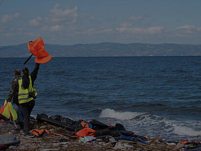 Migrant boat docking on Lesbos, Greece, highlighting the Mediterranean migration challenge
