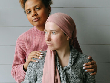 Women supporting each other through illness, a gesture of hope and friendship
