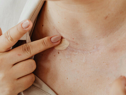 A woman putting concealer over her scar, reflecting the hidden fear and pain of domestic violence and abuse
