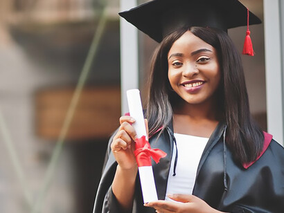 In a moment of triumph, a young female student confidently poses with her diploma, symbolizing not just academic success but also the resilience and pride of her educational journey