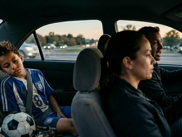 A child processing a painful loss in the back seat, representing the moments when parental support matters most