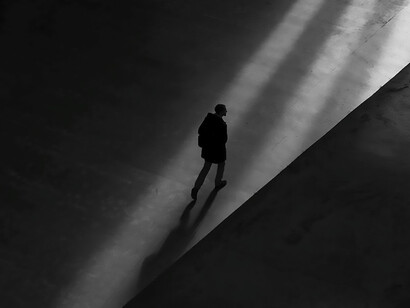 A person walking alone, in a distant place, alone