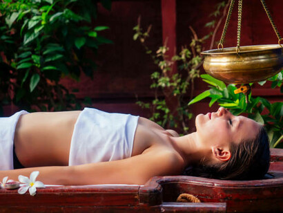 Shirodhara oil therapy, a calming alternative treatment from Ayurveda, performed in an Indian spa setting to promote deep relaxation and balance