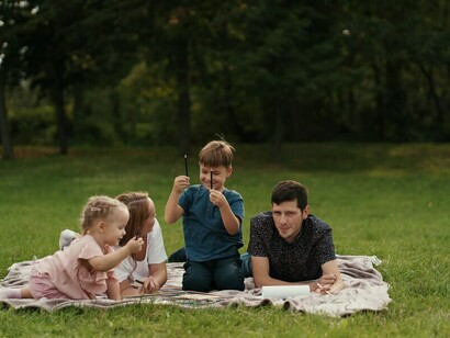 In the midst of a power outage, a beautiful family finds peace and connection, spending time together outdoors with quiet resilience