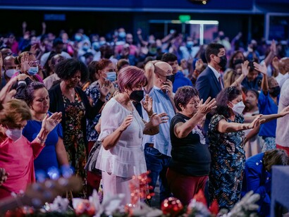 People gathered inside a church, reflecting a modern society where faith continues to shape public life