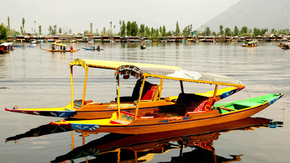 Colourful tour boats drifting across a peaceful lake in Shillong, Meghalaya, India