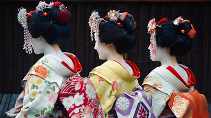 Women dressed in traditional Japanese attire: elegant kimonos with vibrant colors and intricate floral patterns are present in Japan's streets even nowadays