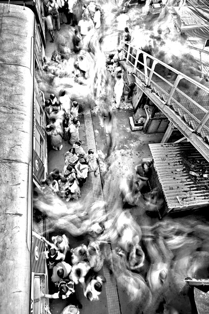 A rushing crowd at a train station—an image of speed without stillness, motion without meaning