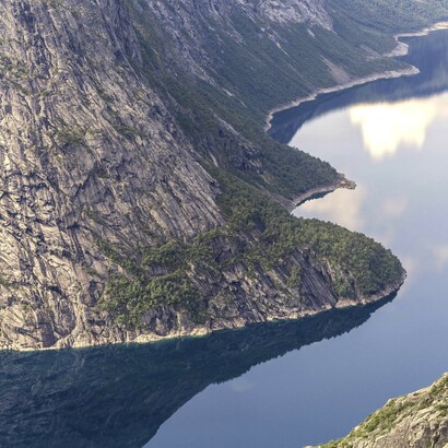 Tranquil water flowing between two mountains