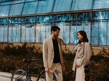 A couple having a thoughtful conversation while sitting on a quiet street