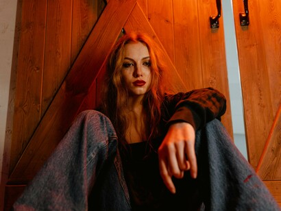 A woman sitting heavy with emotion, highlighting the psychological pivot point after heartbreak