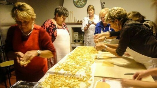 A group of nonnas cooking pasta