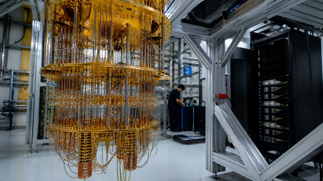 A state-of-the-art quantum computing laboratory featuring a cryogenic quantum processor and advanced computing systems, reflecting the rapid transition of quantum technology from experimental research to real-world industrial applications