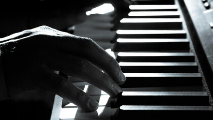 Hands move across the piano, channeling talent shaped by conflict, culture, and resistance