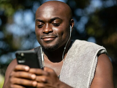 A man focused on his phone, reflecting how mobile technology has become an essential financial tool