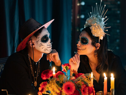 In Mexico, two people dress up on the Day of the Dead, a day of remembrance for loved ones who have gone