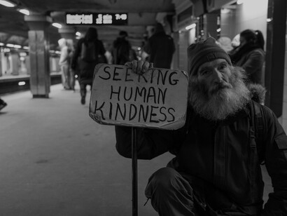 Michael is a homeless man in a Boston, Massachusetts subway station, holding sign seeking human kindness