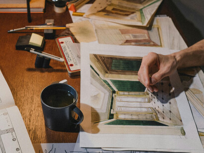An overhead view of a creative architecture student working on an architectural design in a bright, inspiring workspace