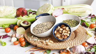 Close-up of a bowl of chia seeds surrounded by other healthy superfoods on a kitchen table