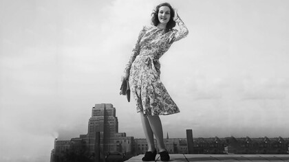 Despite restrictions on certain design elements to conserve valuable materials, wartime "austerity" fashion was far from dull, as evidenced by this vibrant purple, green, and mauve dress designed by Norman Hartnell, which cost 7 clothing coupons