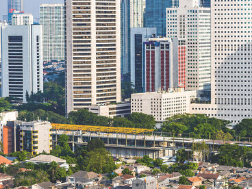 Jakarta’s modern skyline and financial district seen from above, reflecting the contrasts of urban growth and social inequalit