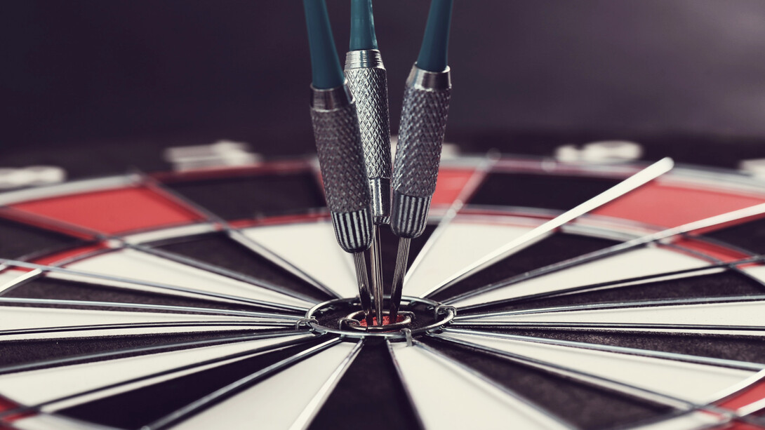 Darts hitting the bullseye, symbolizing success