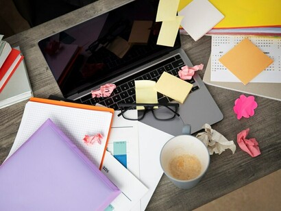 The mess on the office desk, coupled with the fast-paced world and digital anxiety, adds to the pressure of an already hectic work environment