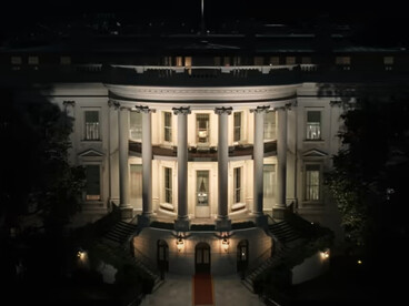 A dimly lit White House with a glowing red carpet leading to its entrance serves as a symbol of power in The Residence, where staff and secrets collide in a high-stakes whodunit
