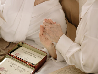 A couple sharing a quiet moment over preserved letters, symbolising love and connection that outlast generations