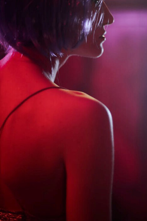 A Russian girl in a silvery dress and wig, dancing at a nightclub