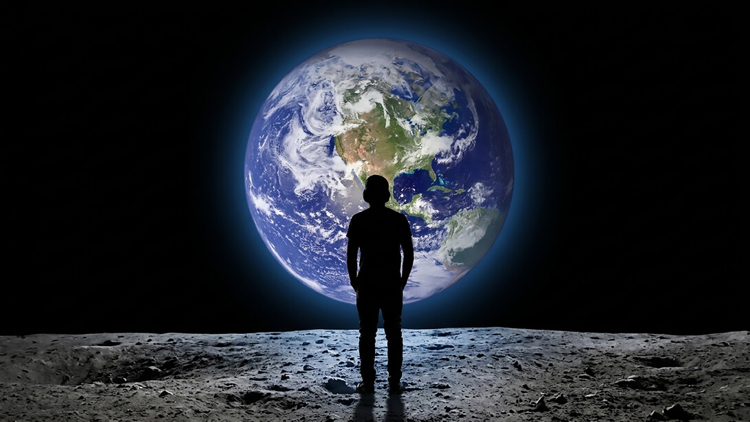 Teenager viewed from behind gazing at planet Earth from outer space