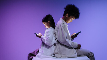 Lost in their phones, these young minds reflect the growing addiction to social media that fuels anxiety and distracts from meaningful experiences