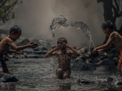 Young monks joyfully bathing in the river, reveling in the moment