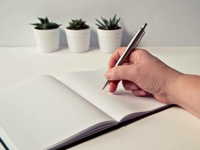 Jotting down notes on a pad with a pen is the ideal way to begin brainstorming for a startup concept