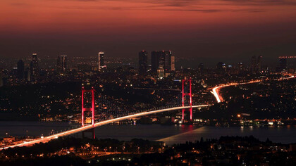 The Bosphorus Bridge comes alive with a mesmerizing glow as night falls over Istanbul