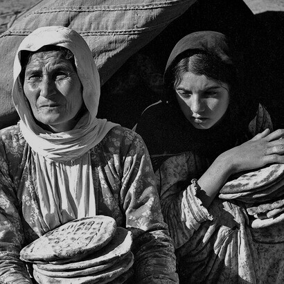Palestine refugee women receiving their meal of bread from United Nations Relief for Palestine Refugees (UNRPR), 1948