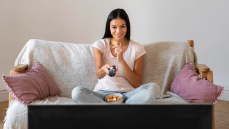 A woman enjoys quality time watching her favorite TV shows