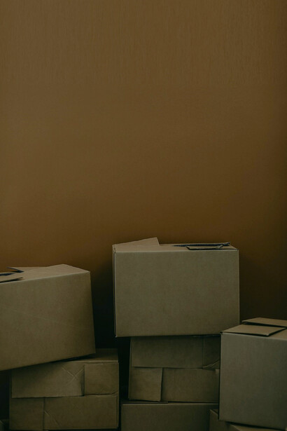 The room was filled with neatly stacked boxes, a tangible representation of the upcoming adventure that awaited in a new and unfamiliar place