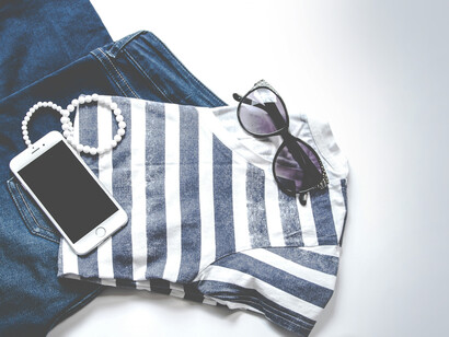Conjunto de ropa, un celular, un collar y unos lentes