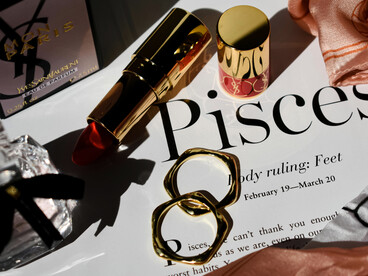Lipstick and rings featured on a magazine page