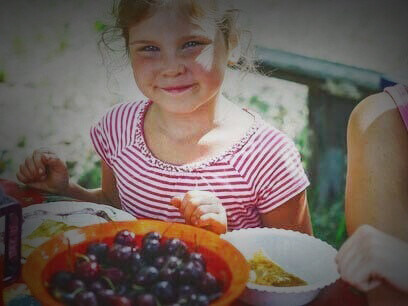 A happy and healthy toddler having some fruit fun on the table; research has increasingly shown that [the gut microbiome can influence mood and the development of depressive disorders