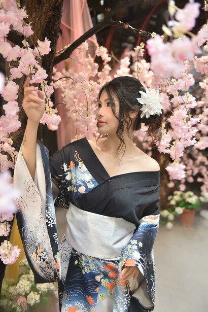 A woman in a kimono among cherry blossoms in japan