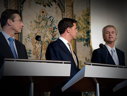 Party chairmen Mark Rutte (VVD) and Maxime Verhagen (CDA) listen attentively to PVV faction leader Geert Wilders during the presentation of the coalition and tolerance agreement