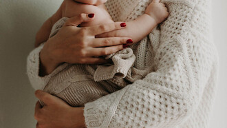 A mother tenderly cradles her child, a reminder that amidst challenges and choices, love remains the guiding force