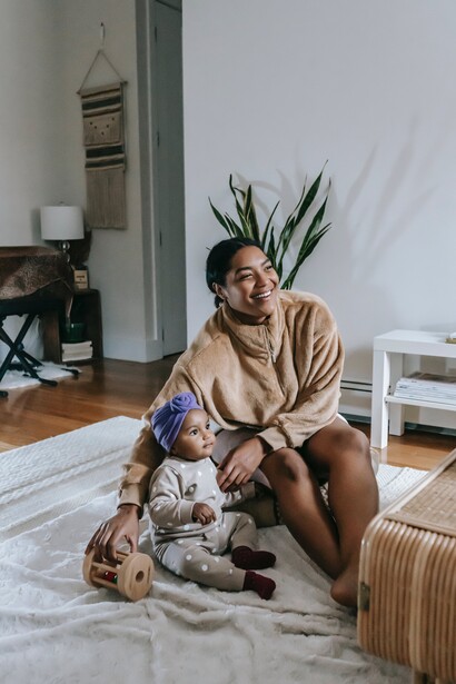 A mother and her baby sat on a rug. People should find out what they want 