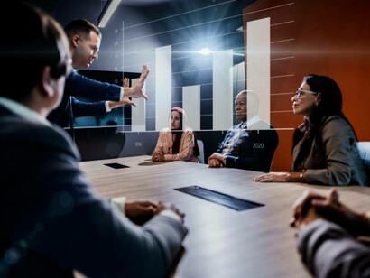 A man using a hologram during a meeting at the office, discussing global challenges and solutions through international collaboration