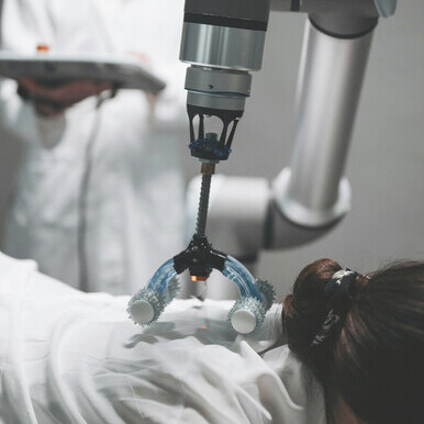 A scientist tests a robotic device, highlighting human-robot teamwork in modern industry