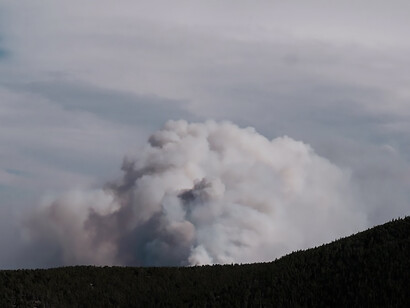 Vividly portraying the expansive reach of the smoke plume as a consequence of the fire's influence